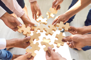 image of employees holding jigsaw puzzle pieces